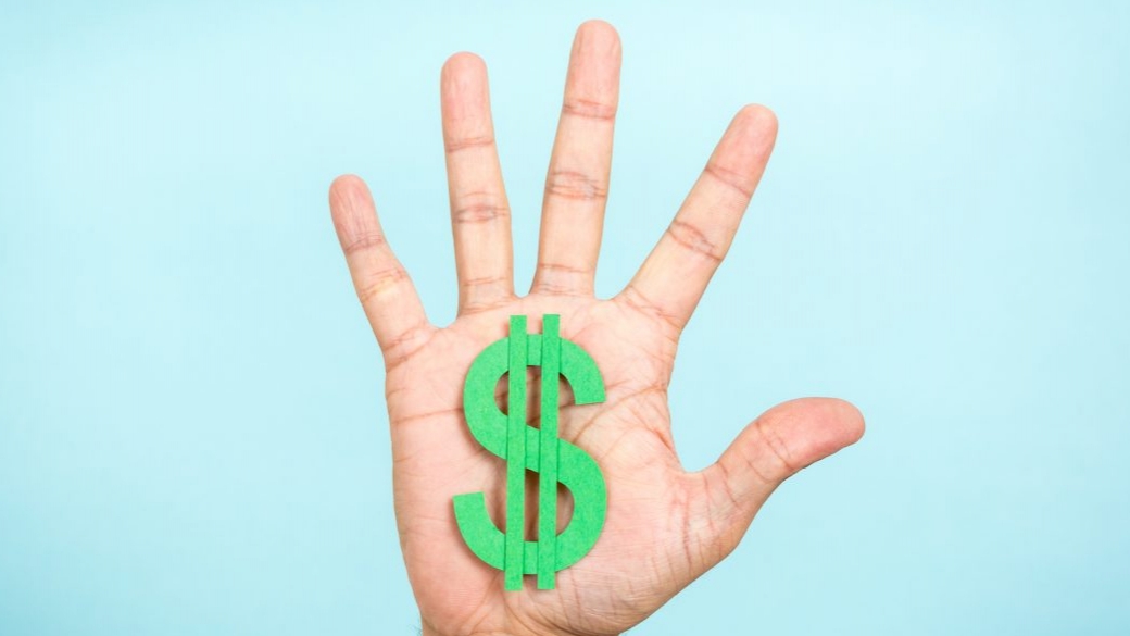 Hand up showing/catching a green dollar symbol with blue background.